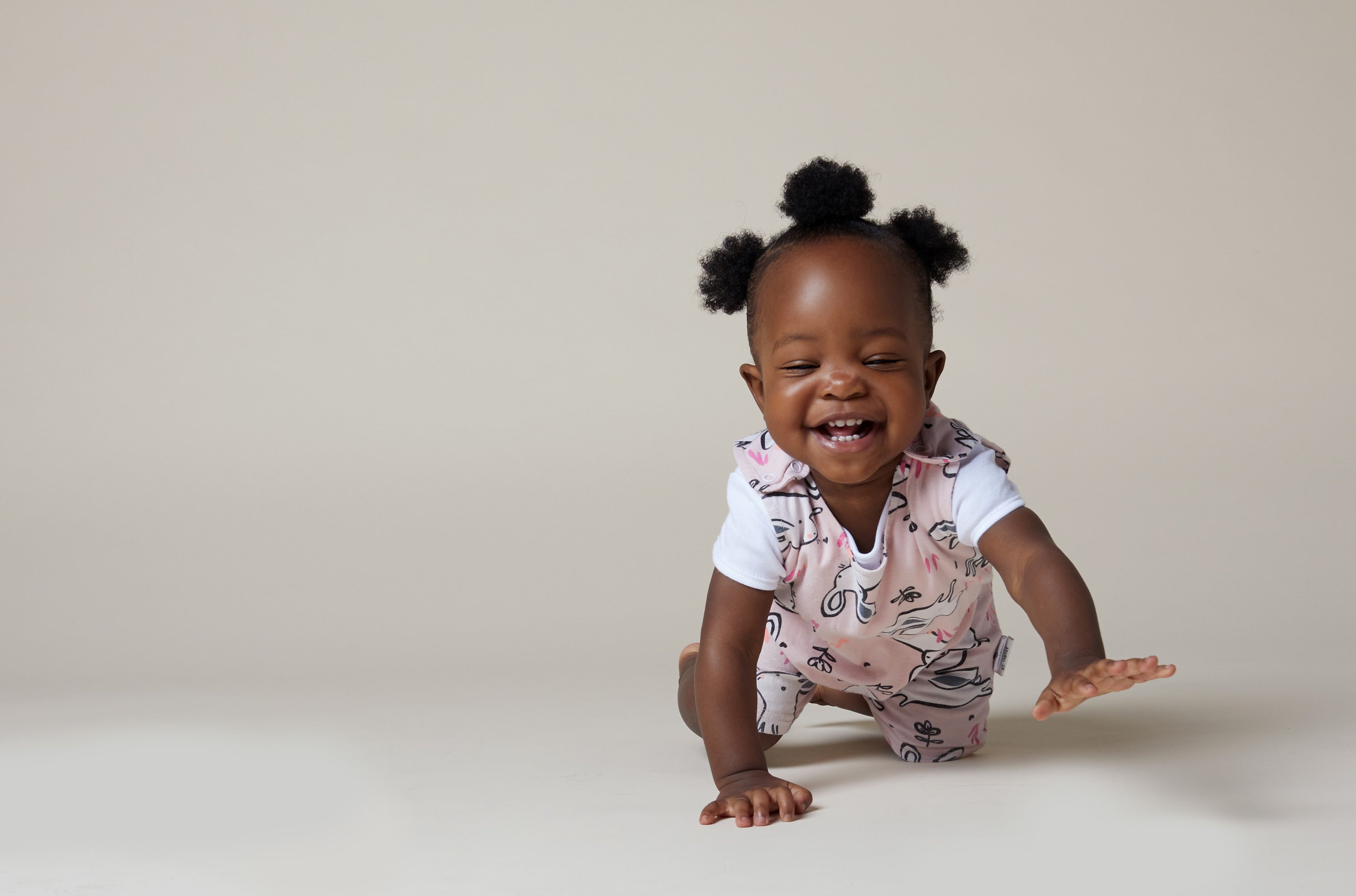 picture of black little girl with 3 hair puffs crawling 